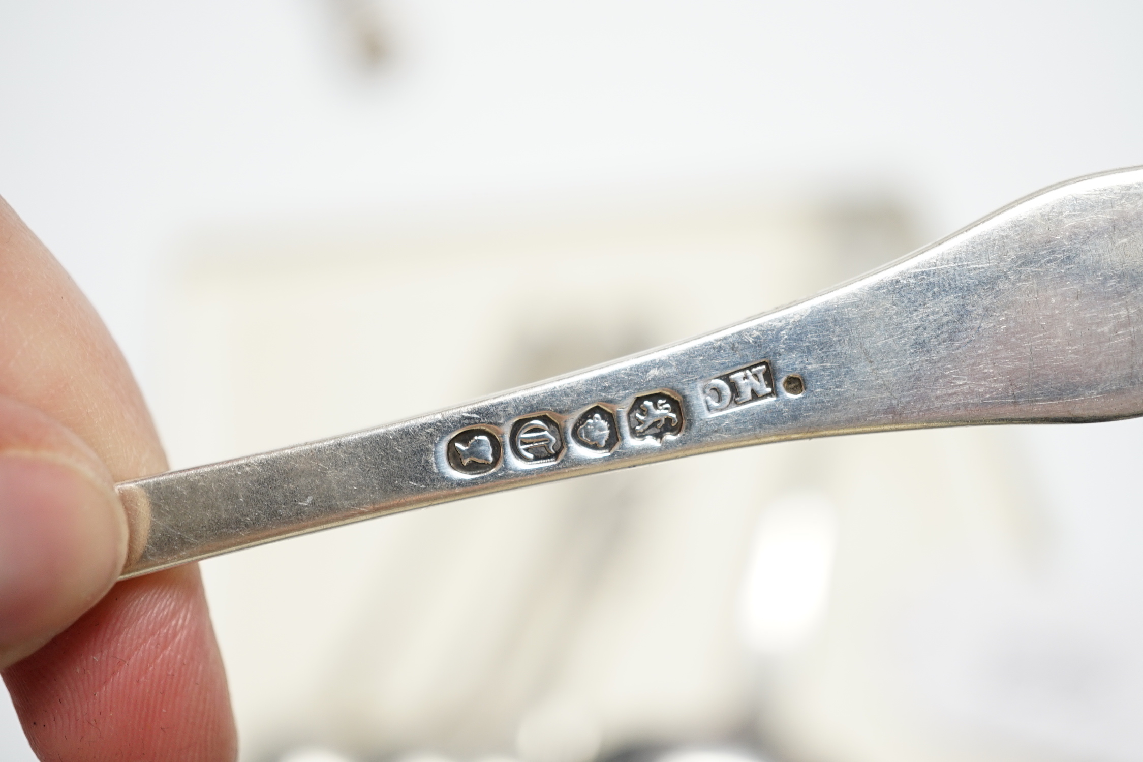 A William IV silver fiddle pattern sauce ladle, London, 1831 and six other assorted silver spoons.